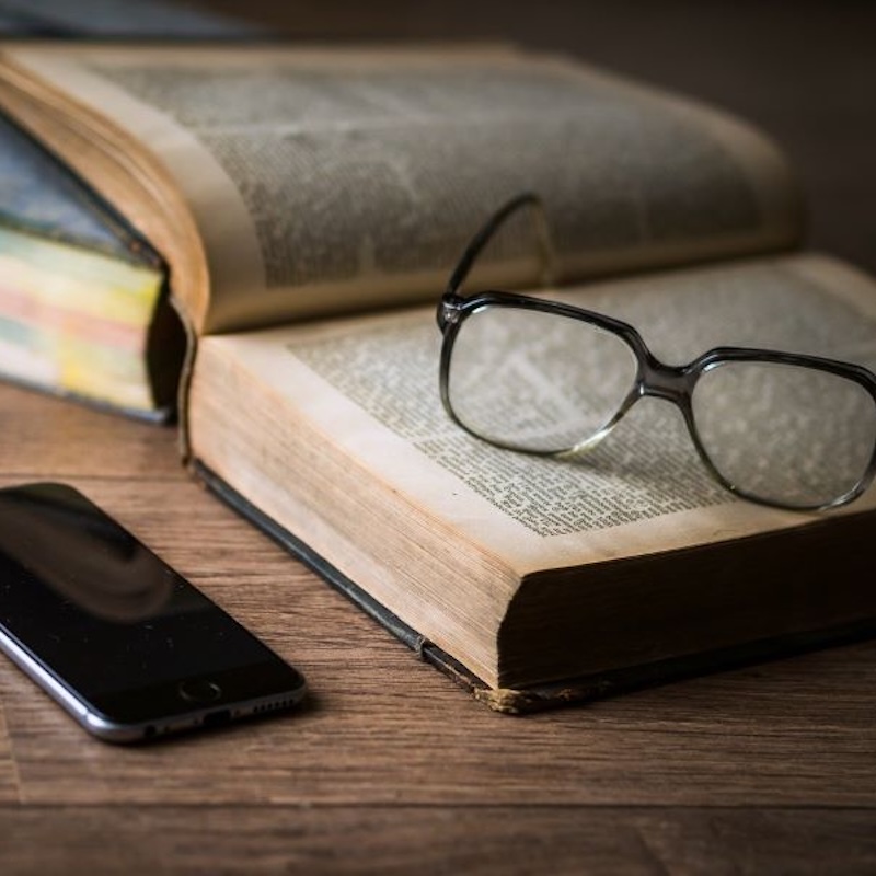book with glasses and phone