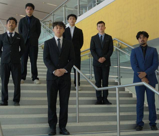 Group of young men with IFC banner