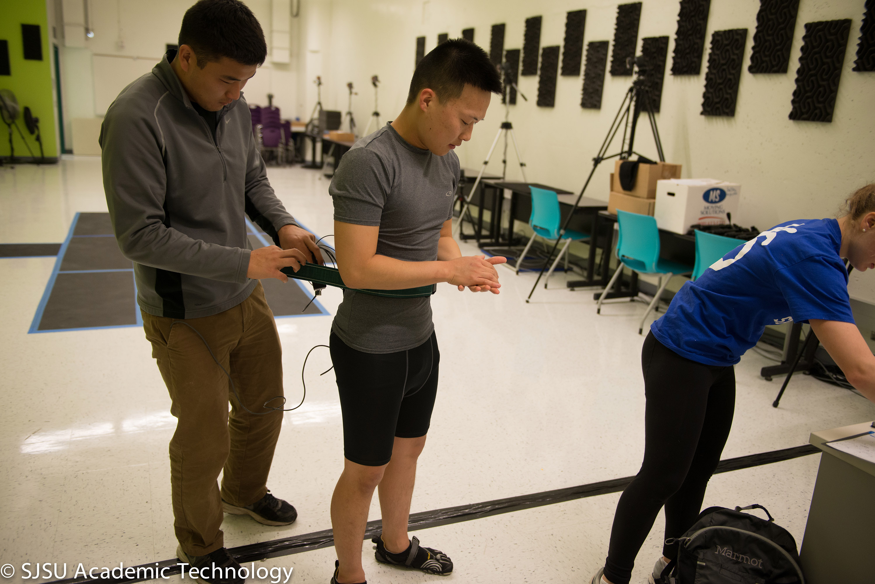 Students working with specialized eqiupment in a biomechanics lab